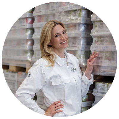 Katharina Miklauz standing in front of pallets wrapped in film